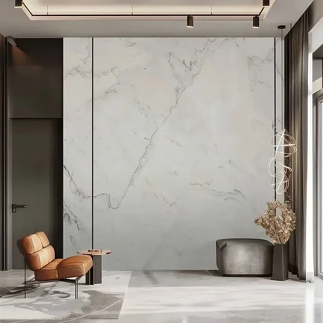 A sophisticated, ultra-modern seating area highlighted by a large seamless white marble accent wall with delicate, asymmetrical grey veining.