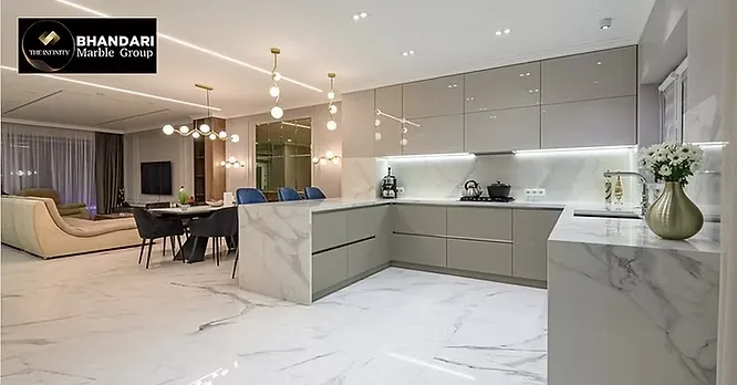 A contemporary kitchen and open living space by Bhandari Marble Group displaying seamless white marble flooring and matched countertops.
