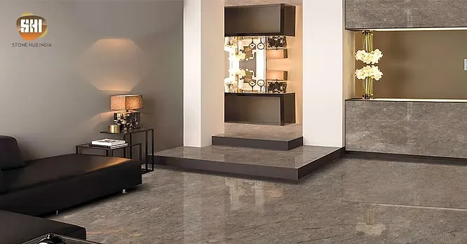 A sophisticated lounge area presented by Stone Hub India featuring glossy, earth-toned grey marble flooring and matching wall panels.