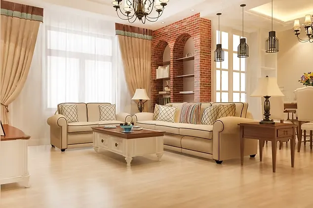 Bright elegant living room with comfortable cream sofas, a brick accent wall, and classic hanging lamps.