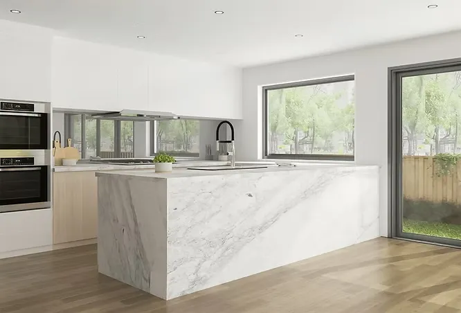 A minimalist kitchen featuring a sleek waterfall island topped with elegant white quartzite displaying soft grey veining.