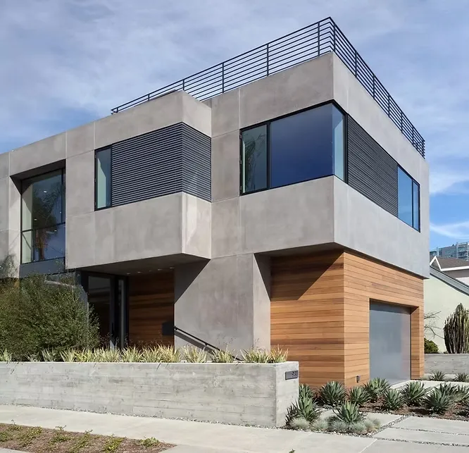 Cubist modern home featuring smooth gray fiber cement panels paired with warm wood cladding and a concrete wall.