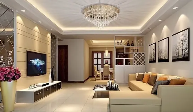 Warm living room showing how layered lighting impacts mood with a crystal chandelier, cove lighting, and wall spotlights.