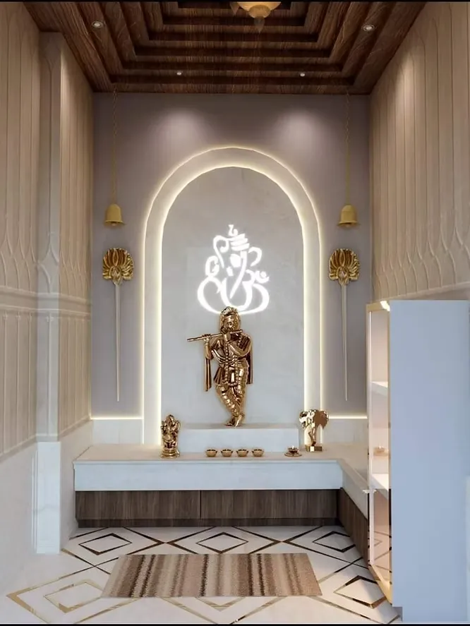 Serene marble pooja room featuring a glowing Ganesha wall outline, a golden Krishna statue, and elegant hanging brass bells.