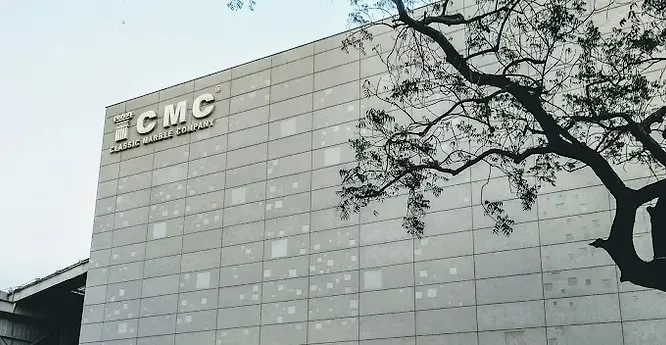 Clean typography logo for Classic Marble Company (CMC), displayed on a dark grey background for high contrast.