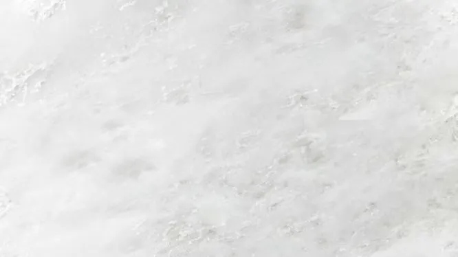 Detailed slab view of Namibian White marble, showing a clean, bright white surface with a faint crystalline texture.