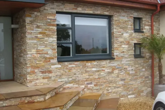 Rustic natural stone cladding creates a premium, earthy aesthetic while providing superior strength and weather resistance.