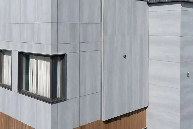 Large-format porcelain slabs bring a modern, seamless look to building exteriors with their stain resistance and durability.