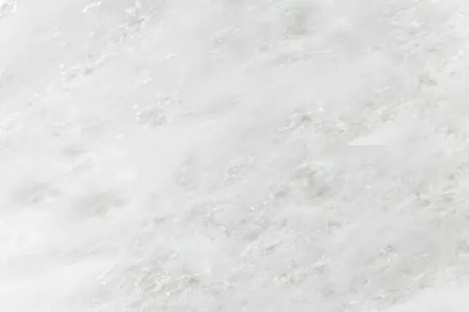 Namibian White Marble, showcasing its unique texture and color. The quarry location of expensive stones directly affects their beauty and value.