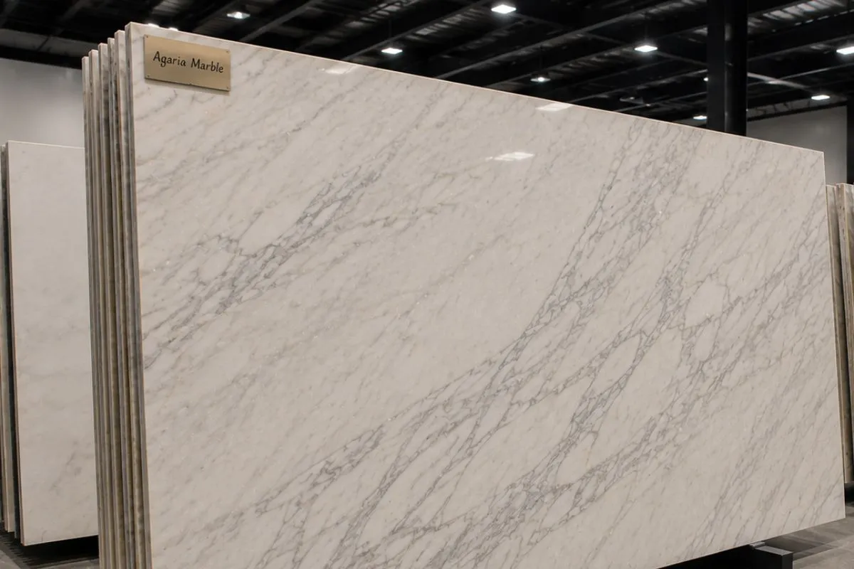 A large slab of white Agaria marble with soft gray lines.