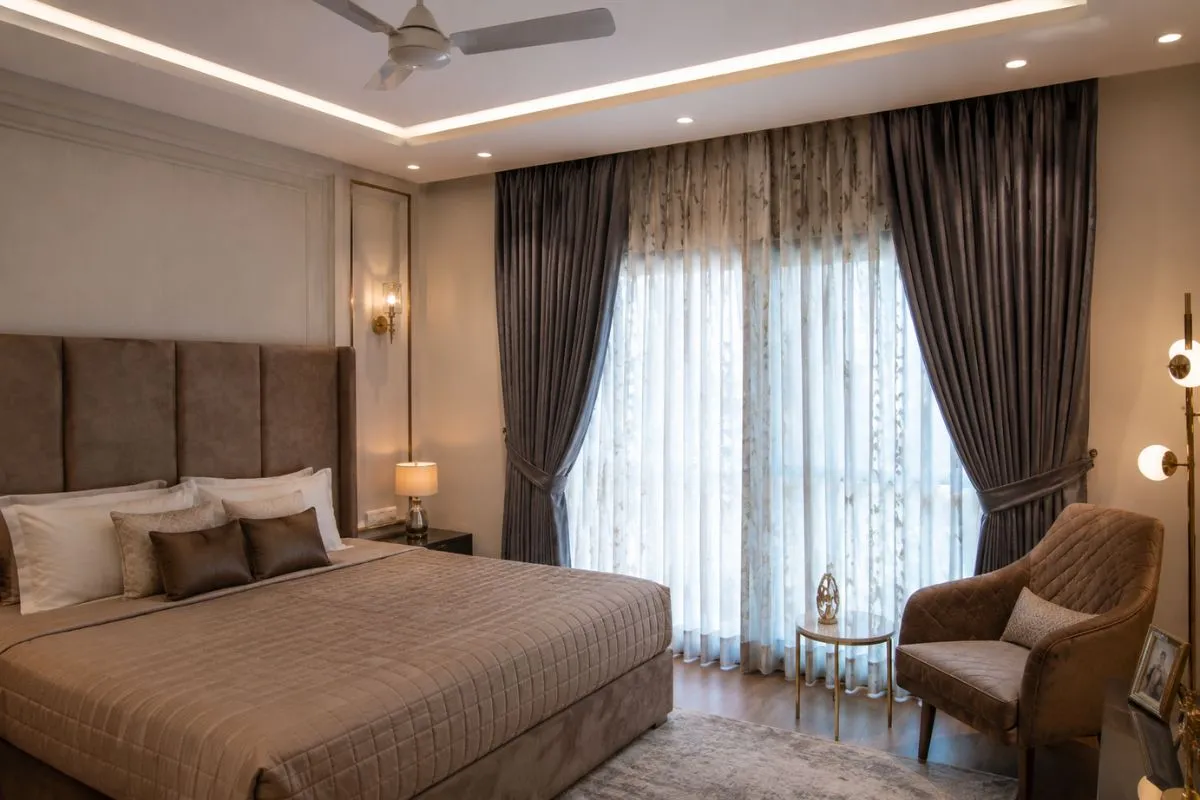 Cozy bedroom with elegant dark curtains and sheer drapes covering window.