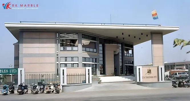 A spacious industrial warehouse facility neatly storing rows of large, premium white stone and marble blocks.