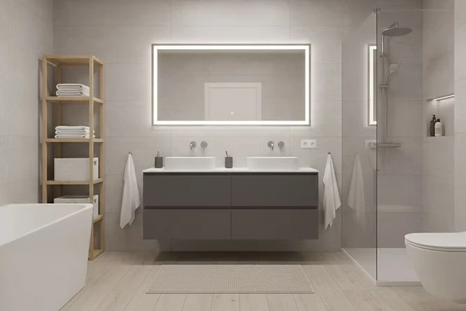 Minimalist space with a large lighted mirror and grey vanity. The simple bathroom decor avoids clutter. Using floating cabinets makes cleaning the floor underneath fast and stress-free.