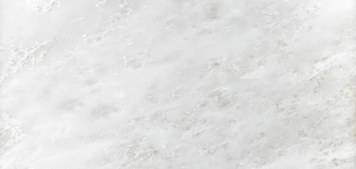 A close-up view of a premium white Namibian marble slab featuring soft, delicate light gray and cream veins.
