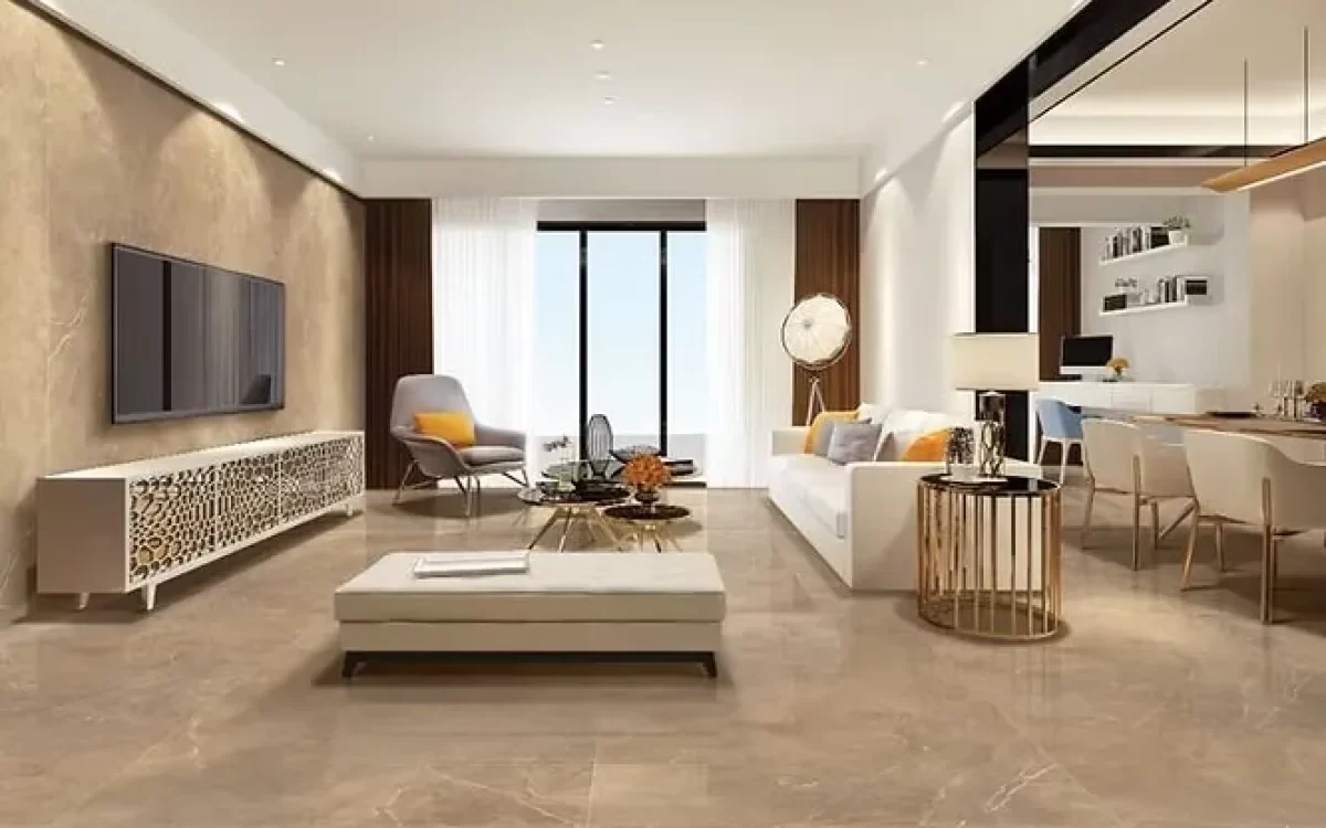 An open-concept luxury apartment living space showing extensive, high-gloss beige marble flooring and a matching polished accent wall behind the entertainment console.