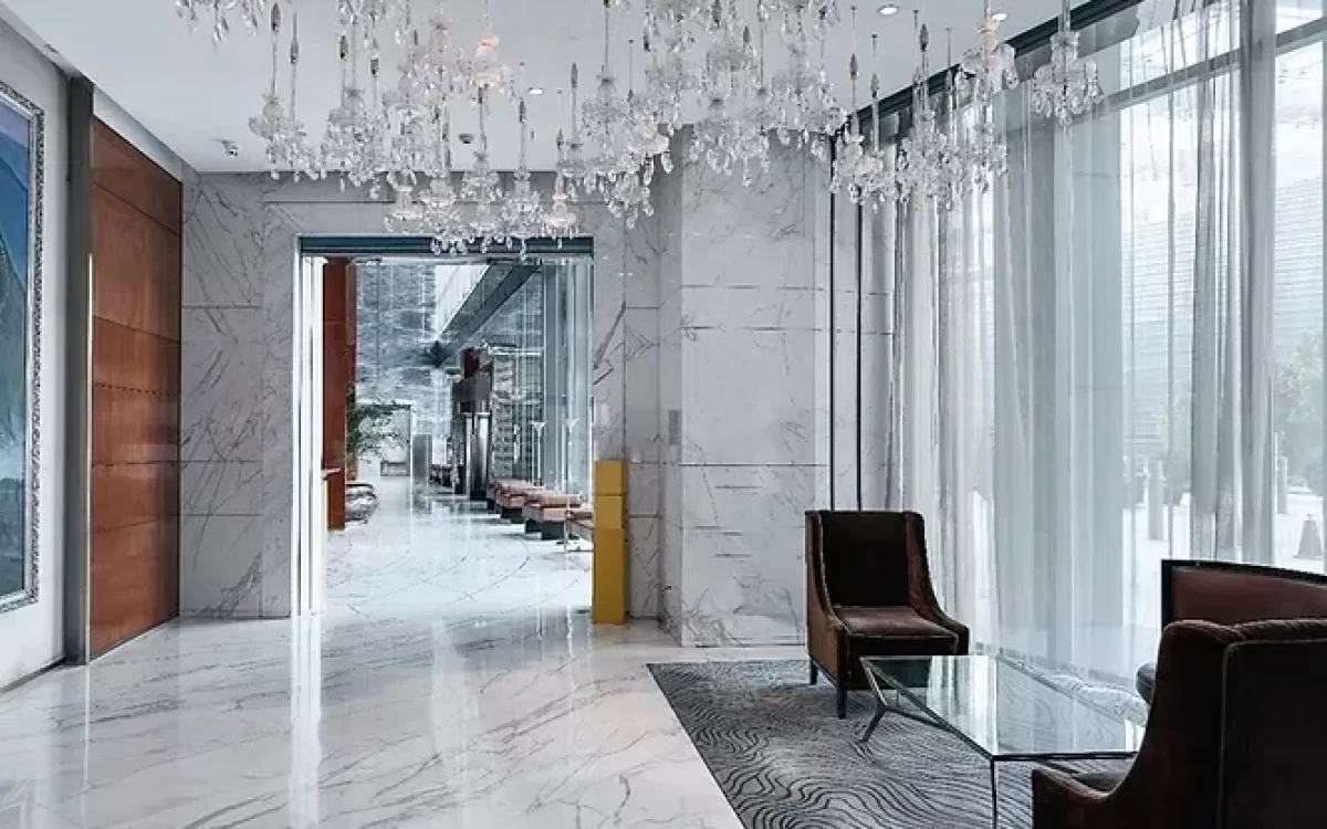 Flawless, highly polished white marble flooring adds a pristine, luxurious touch to a grand hotel lobby or high-end residential entryway.