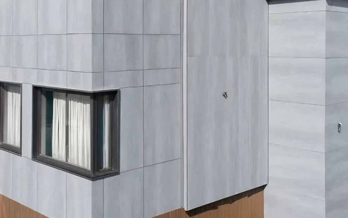 Large-format porcelain slabs bring a modern, seamless look to building exteriors with their stain resistance and durability.