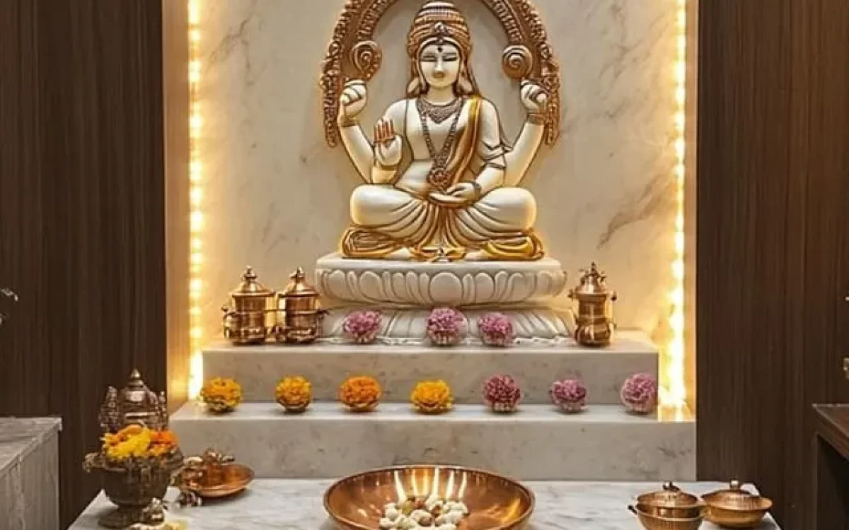 Elegant home temple showing a white marble mandir base, backlit marble panel, and a beautiful white and gold Goddess Lakshmi idol.