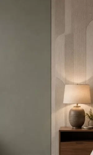 Side-by-side view comparing a plain sage green painted wall with a textured beige patterned wallpaper behind a bed.
